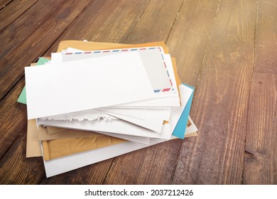 Pile Of Envelopes With Overdue Utility Bills On The Desk