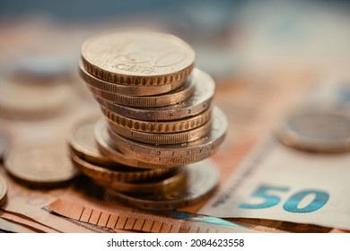 Pile of euro coins on euro notes. - Shutterstock ID 2084623558