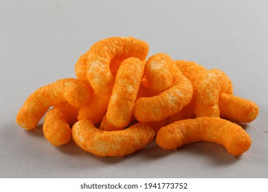 Pile Of Extruded Cheese Puffs Isolated On White.