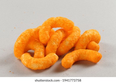 Pile Of Extruded Cheese Puffs Isolated On White.