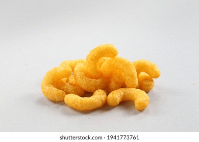 Pile Of Extruded Cheese Puffs Isolated On White.