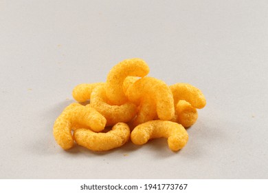 Pile Of Extruded Cheese Puffs Isolated On White.