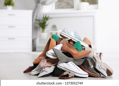 Pile Of Female Shoes On Floor Indoors