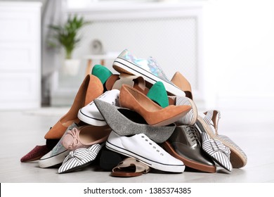 Pile Of Female Shoes On Floor Indoors