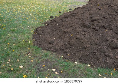 A pile of fertile soil for the lawn. - Shutterstock ID 1858379797