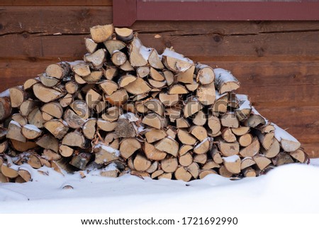 A pile of firewood on the snow