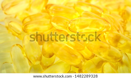 Pile of fishoil capsules Omega 3 and capsules on blurred background ,benefits supplement and support heart health,healthy diet concept, selective focus