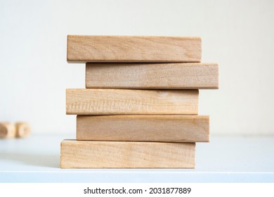 A pile of five wooden blocks on the soft white background. - Shutterstock ID 2031877889