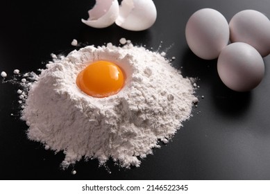 A pile of flour and broken egg cut out. Top view. - Powered by Shutterstock