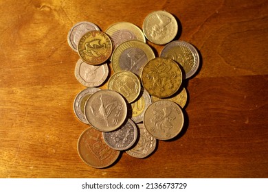 Pile Of Foreign Currency Coins On Table