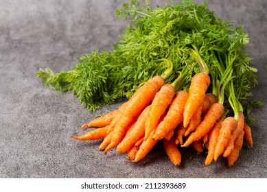 Pile Of Fresh Baby Carrots On Stone Background