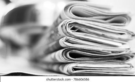 Pile of fresh morning newspapers on the table at office. Latest financial and business news in daily paper. Pages with information (headlines, articles, photos, text). Folded and stacked journals - Shutterstock ID 786606586