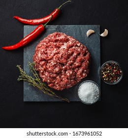 pile of fresh raw minced meat for meatballs with spices (pepper, salt) on a black background. Ingredient for the preparation of meat dishes - Powered by Shutterstock