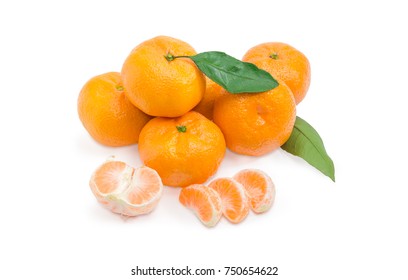 Pile Of Freshly Harvested Mandarin Oranges With Leaves And Half And Several Sections Of Peeled Mandarin Orange On A White Background
