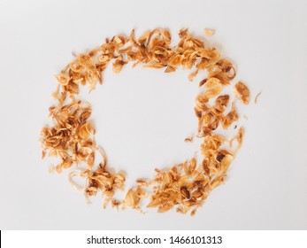 Pile of fried Indonesian Deep Onion fries (Bawang Goreng) or shallots with circle shape isolated on white background.