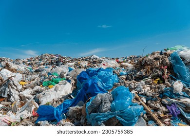 A pile of garbage in a landfill against a blue sky. Plastic scrap in landfill. Concept of ecology.