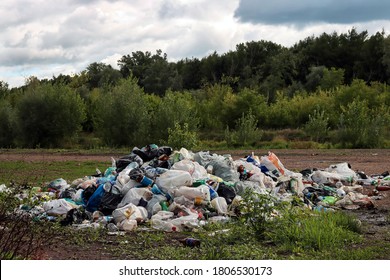 A Pile Of Garbage In Nature Among The Plants.Toxic Plastic Into Nature. Environmental Pollution. Ecological Issue. 