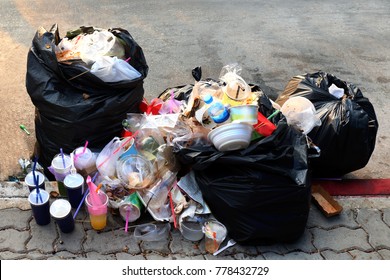 Pile of Garbage plastic black and trash bag waste many on the footpath, pollution trash, Plastic Waste and Bag Foam tray Garbage many on floor, Waste plastic - Shutterstock ID 778432729