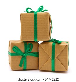 Pile of Gift boxes wrapped in brown paper isolated on white.