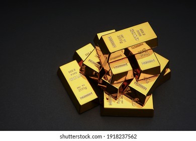 A Pile Of Gold Bar A Black Background. Shiny Precious Metals For Investments Or Reserves.