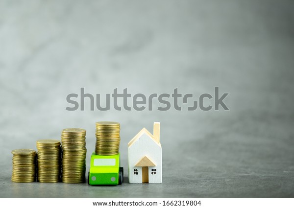 Pile\
of gold coins, car and house for savings buy a home or car. Divide\
the investment for retirement or concept of\
money.