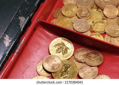 A Pile Of Gold Coins In An Open Cash Box