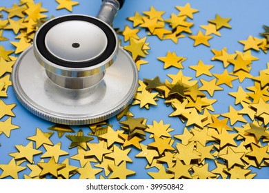 A Pile Of Gold Stars And Stethoscope On A Blue Background, Excellent Healthcare