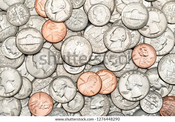 Pile of Golden coin, silver coin, copper coin, quarters,\
nickels, dimes, pennies, fifty cent piece and dollar coins. Various\
USA coins, American coins for business, money, financial coins and\
economy 