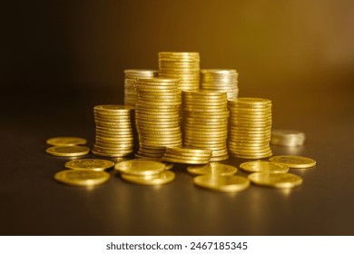 Pile of golden money coin on wood desk and black background. Business and financial concept.  - Powered by Shutterstock