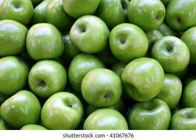 A Pile Of Green Apples At A Farmers Market