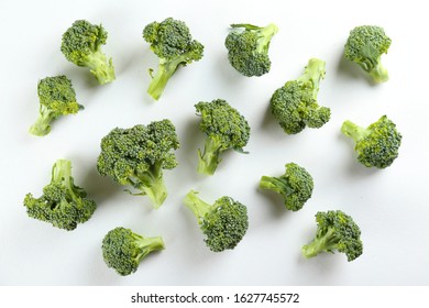 Pile of green raw uncooked broccoli on countertop. Vegan diet concept. Close up, copy space, background, top view.