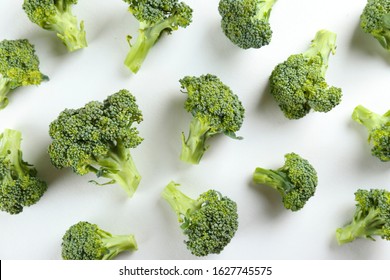 Pile of green raw uncooked broccoli on countertop. Vegan diet concept. Close up, copy space, background, top view.