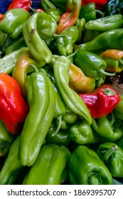 A pile of green and red chili peppers