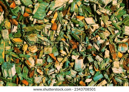 Pile of green wood chips background. Texture of colored wood pieces. Natural bark material pattern. Decorative mulch. SHOTLISTeco