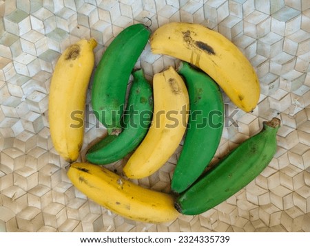 Pile of green and yellow bananas.  Ripe and unripe bananas