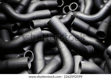 Pile of grey rubber connecting pipes as background