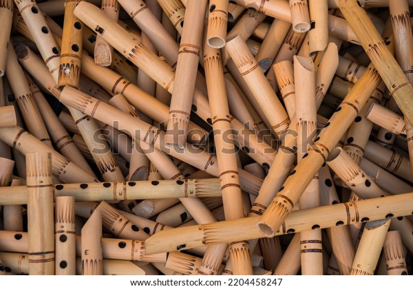 Pile of half-finished bamboo flutes,\
handmade bamboo flute production process by craftsmen, bamboo\
flutes being dried before finishing and\
marketed
