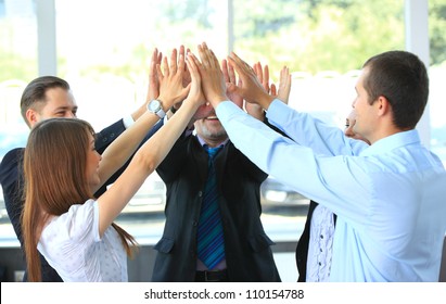 Pile of hands - Successful business team celebrating their success with a high five