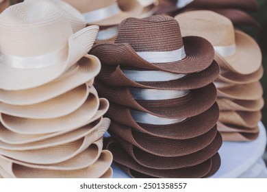 Pile of hats in the hat shop background. Many Panama hats in a store street market. different styles of Hats for sale  - Powered by Shutterstock