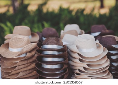 Pile of hats in the hat shop background. Many Panama hats in a store street market. different styles of Hats for sale  - Powered by Shutterstock