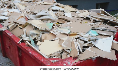 Pile of Hazardous Construction Materials Waste In Large Metal Garbage Dump Container Bin