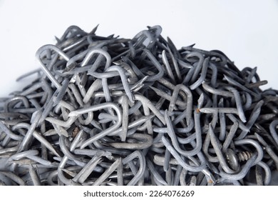 pile of heavy barbed wire staples for construction and carpentry