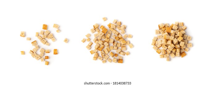 Pile of homemade bread croutons isolated on white background top view. Crispy bread cubes, dry rye crumbs, rusks, crouoton or white roasted crackers cube heap collection