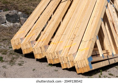 A Pile Of House Rafters Waiting On The Ground