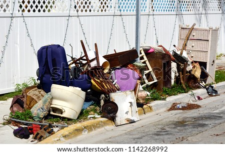 A pile of household furnishings, damaged by Hurricane Irma, placed curbside, awaiting trash removal.