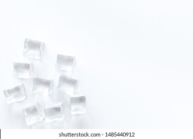 Pile of ice cubes on white bar desk background top view mockup