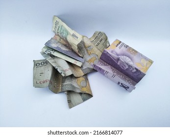 Pile of Indonesian rupiah money paper notes on a white background. Business concept. Rupiah is indnesia currency. Crumpled rupiah money.