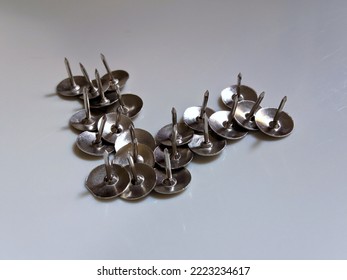 Pile Of Iron Thumb Tacks Isolated On White Background