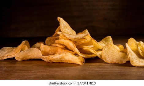 Pile Of Kettle Chips On Wood Backdrop