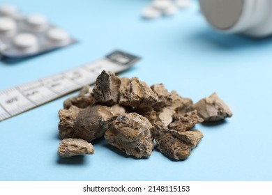 Pile of kidney stones on light blue background, closeup - Shutterstock ID 2148115153